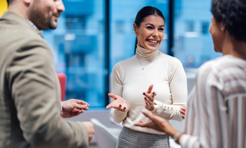 Two colleagues, making their new coworker feel welcomed.